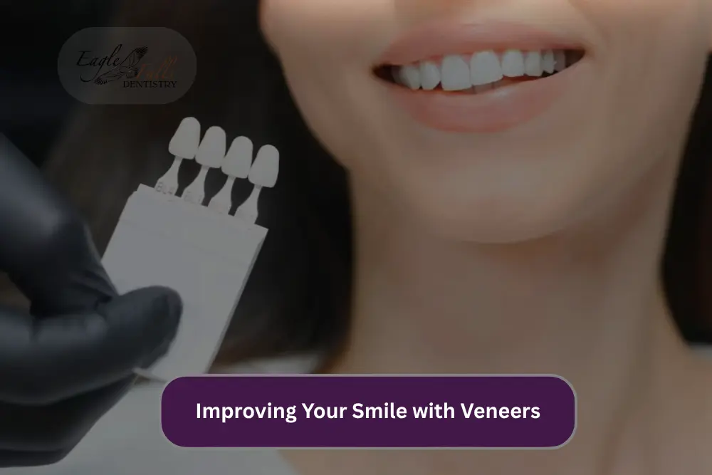 Improving your smile with veneers, showing a dental professional holding veneer samples beside a smiling patient